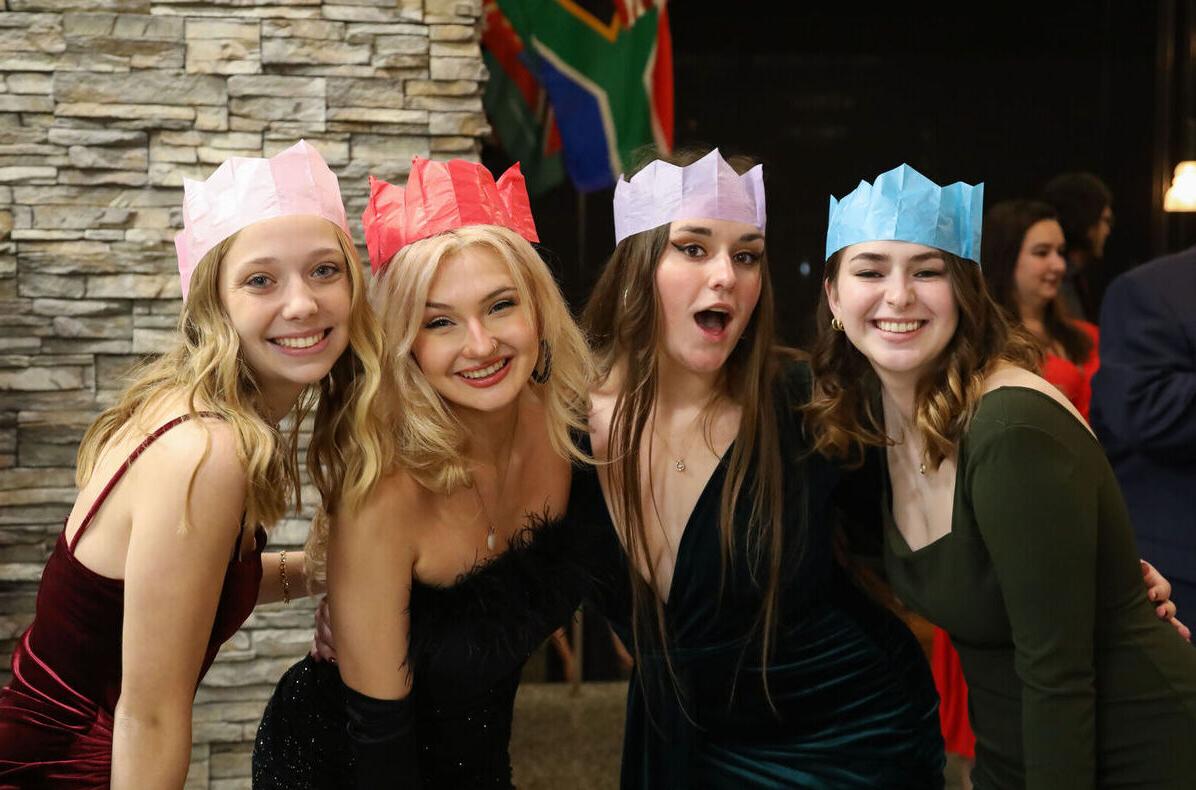 Four female students pose for the camera during the Holiday Banquet